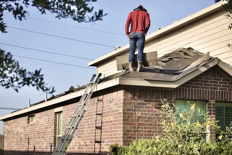 Professional roofer working on a residential roof in North Oaks